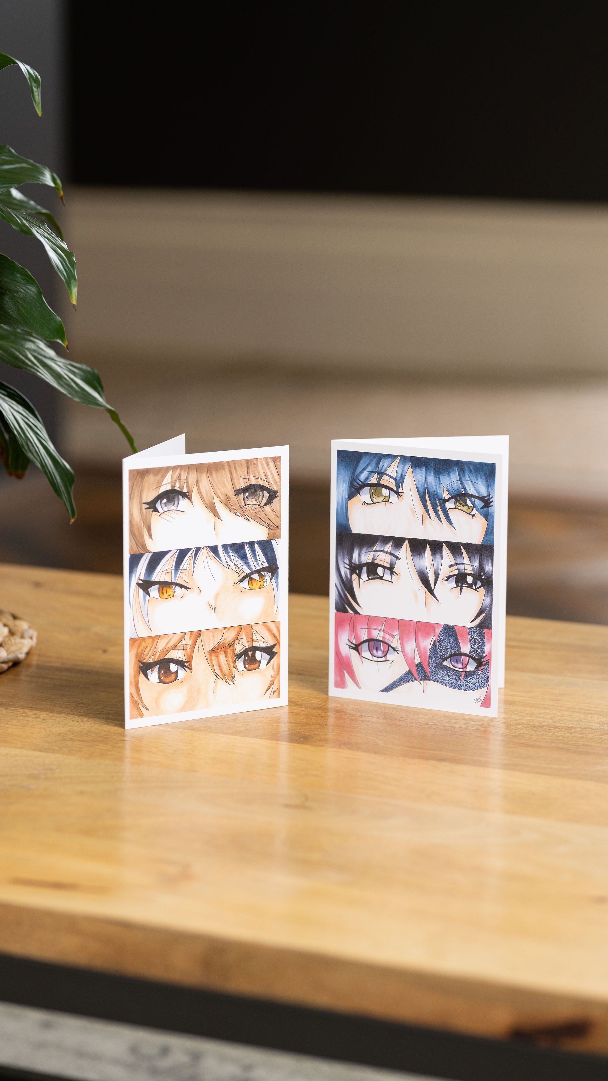 Boy's Eyes With Girl's Eyes A6 Greetings Card On A Wooden Table With A Plant